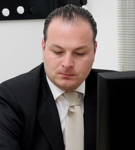 serious manager in suit writing email